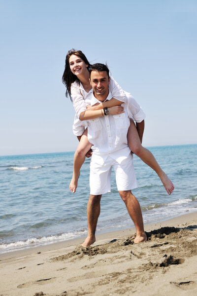 Happy young couple have fun on beach