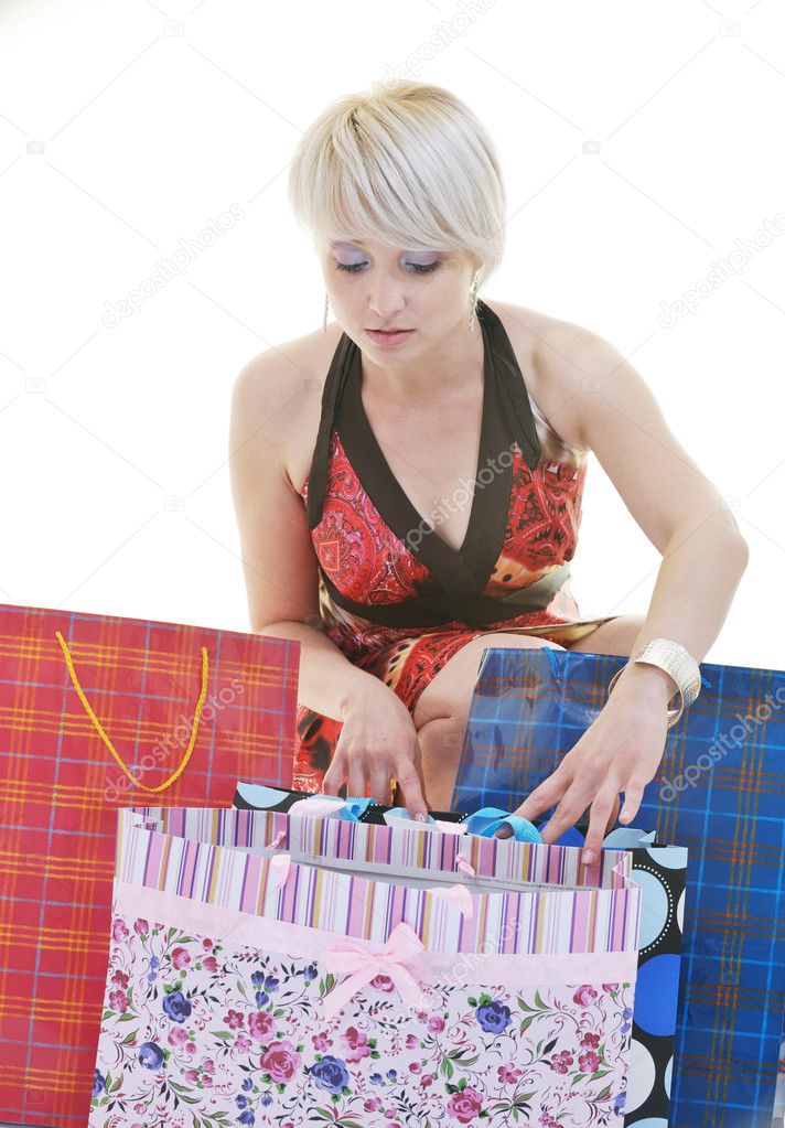 Happy young adult women shopping with colored bags