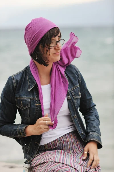 Beautiful young woman on beach with scarf — Stock Photo, Image