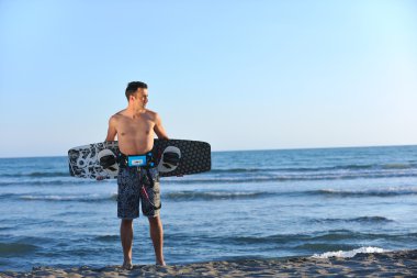 sunset beach adlı bir genç kitsurf adam portresi