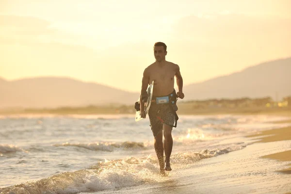 Portrait of a young kitsurf man at beach on sunset — Stok Foto