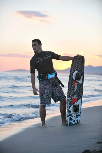 Portrait of a young kitsurf man at beach on sunset — Stock Photo, Image