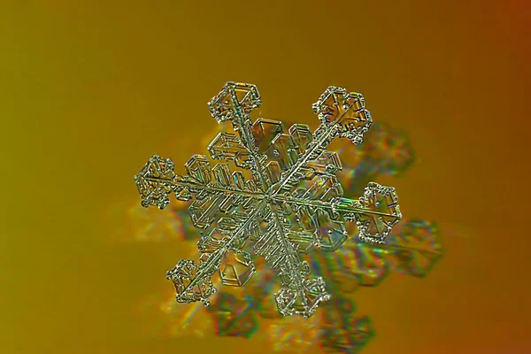 Snowflake on yellow — Stock Photo, Image