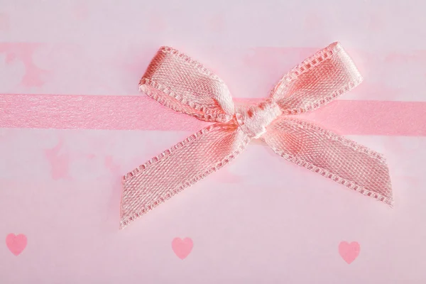 Bow on background with hearts — Stock Photo, Image