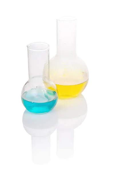 Flasks with yellow and blue chemical liquid — Stock Photo, Image