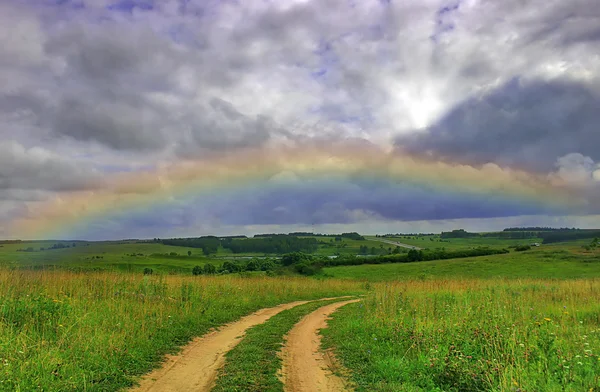 Road under rainbow — Zdjęcie stockowe