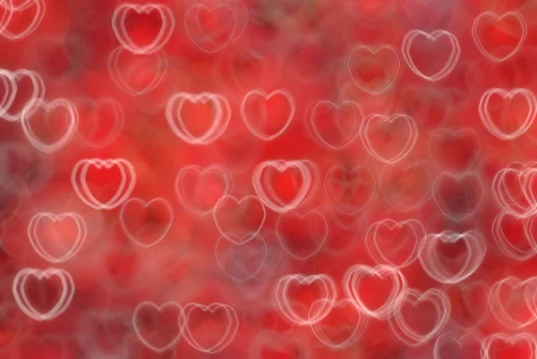 Abstrakter roter Hintergrund mit weißen Herzen — Stockfoto