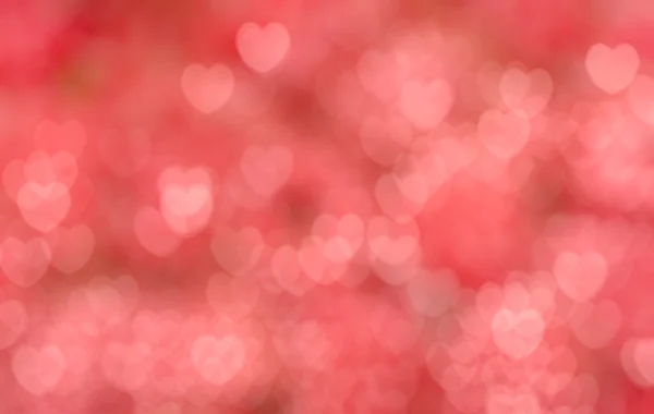 Fundo borrão vermelho com corações cor de rosa — Fotografia de Stock