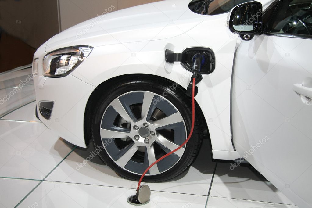 White hybrid car on recharge