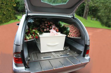 White coffin in a grey hearse clipart