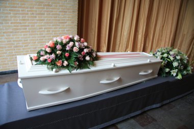 White coffin with pink sympathy flowers clipart