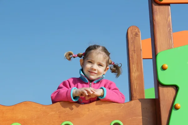 Mały dziewczyna pozuje w plac zabaw dla dzieci — Zdjęcie stockowe