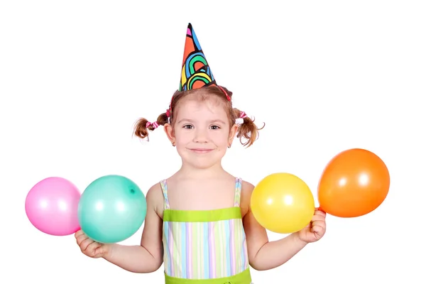 Kleines Mädchen mit Geburtstagsmütze und Luftballons — Stockfoto