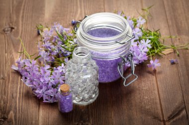 Spa still life - bath salt and spring flowers clipart