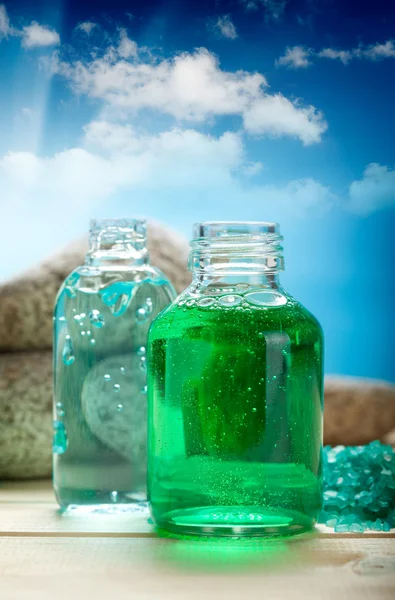 Aromatherapy oils on blue sky background — Stock Photo, Image