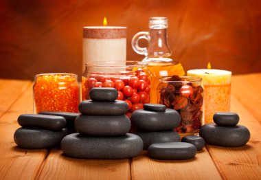 Spa supplies - essential oil, bath salt and massage stones clipart