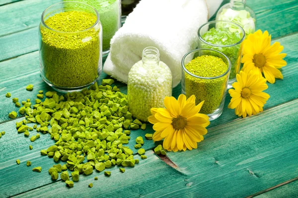 Yellow flowers and green bath salt — Stock Photo, Image