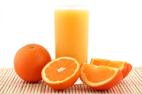 Orange juice on bamboo matting — Stock Photo, Image