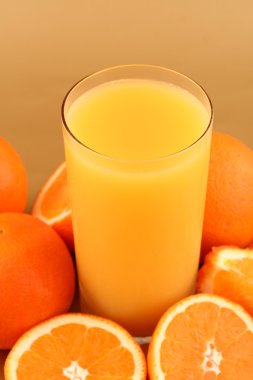 Orange juice on oranges background clipart