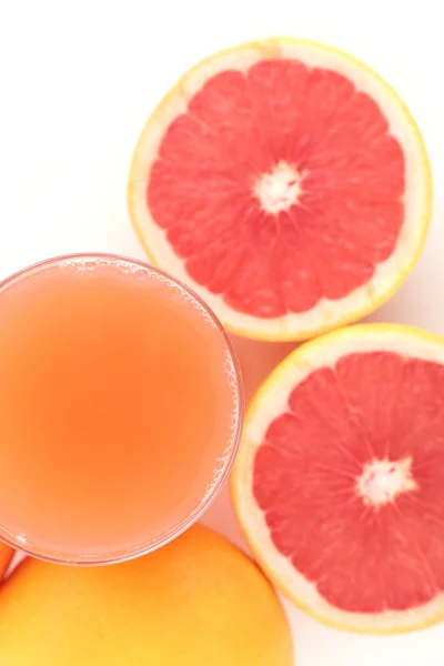 Грейпфруты - сок и фрукты — стоковое фото