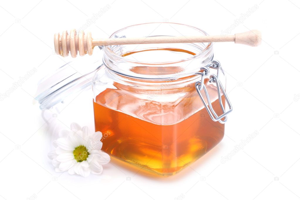 Jar of honey , dipper and flower