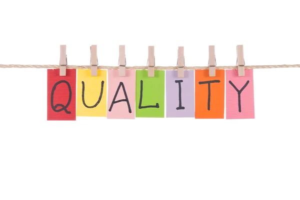 Quality, words hang by wooden peg — Stock Photo, Image