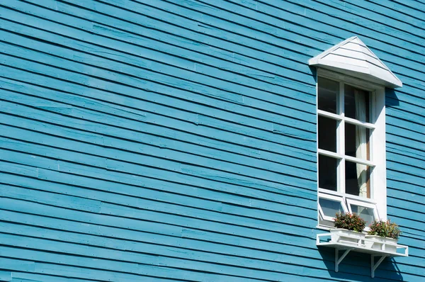 Stock image White window on blue wooden wall