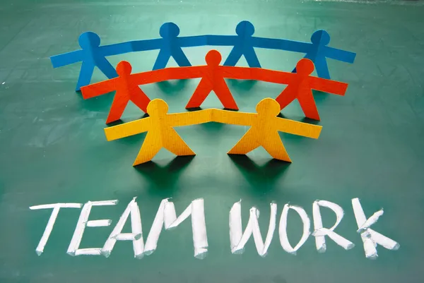 Teamwork words and colorful paper dolls — Stock Photo, Image