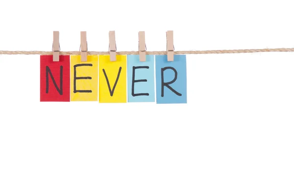 Never, Wooden peg and colorful words — Stock Photo, Image