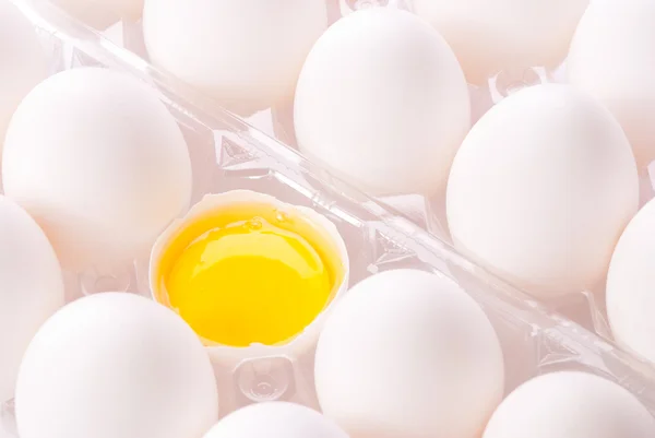 Fresh group eggs with yolk in box — Stock Photo, Image
