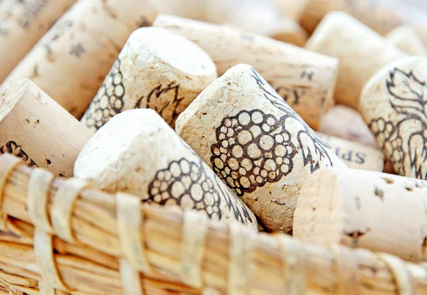 Decorative wine corks in wicker basket — Stock Photo, Image
