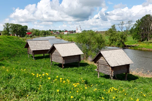 Russian wooden houses at a river bank. Huts on 