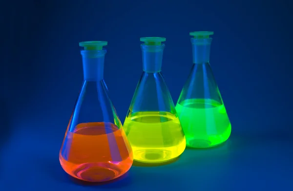 Fluorescence in flasks on blue — Stock Photo, Image