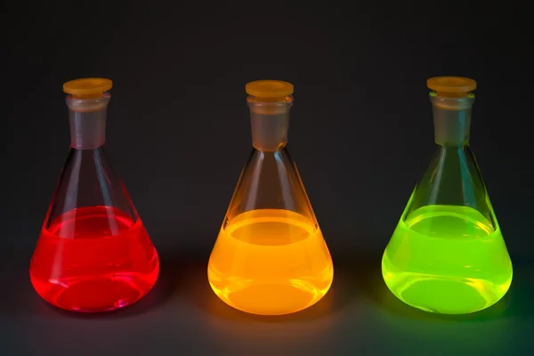 Fluorescence in three flasks Stock Image