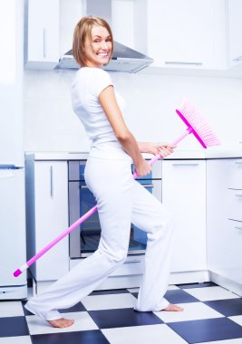 Housewife with a broom clipart