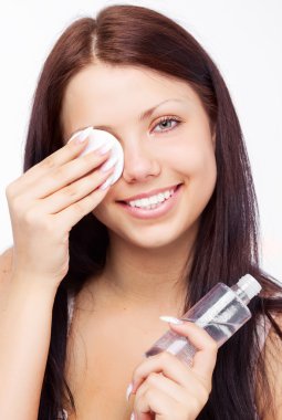 Woman removing makeup clipart