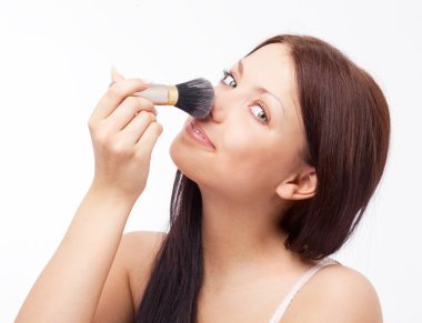 Woman applying powder clipart