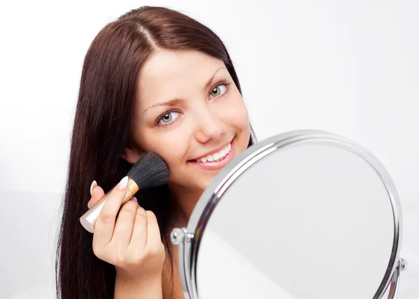 Woman with a mirror Stock Image