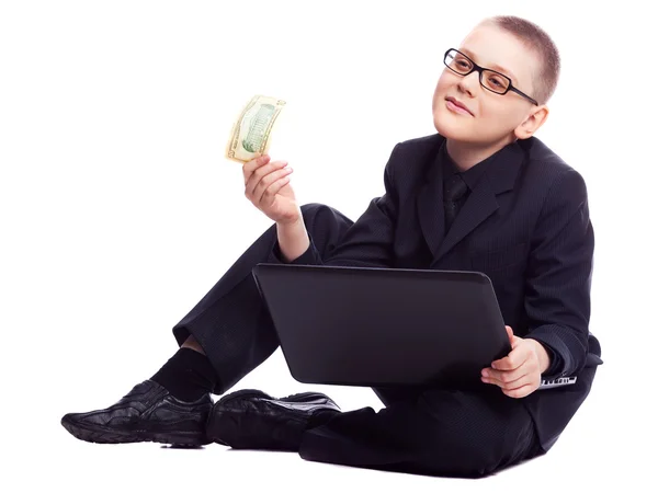 Boy with laptop and money — Stock Photo, Image