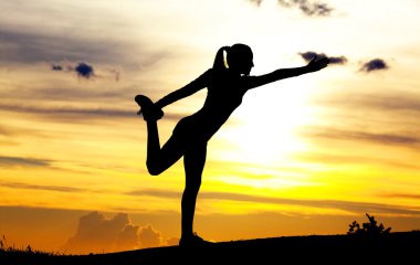 Woman practicing yoga clipart