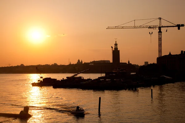 Industrial harbor at sunset and a crane — Stock Photo, Image
