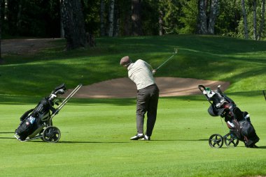 Golfer finishes his swing clipart