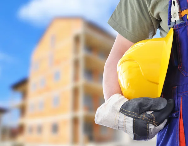 Worker with blurred construction in background — Stock Photo, Image