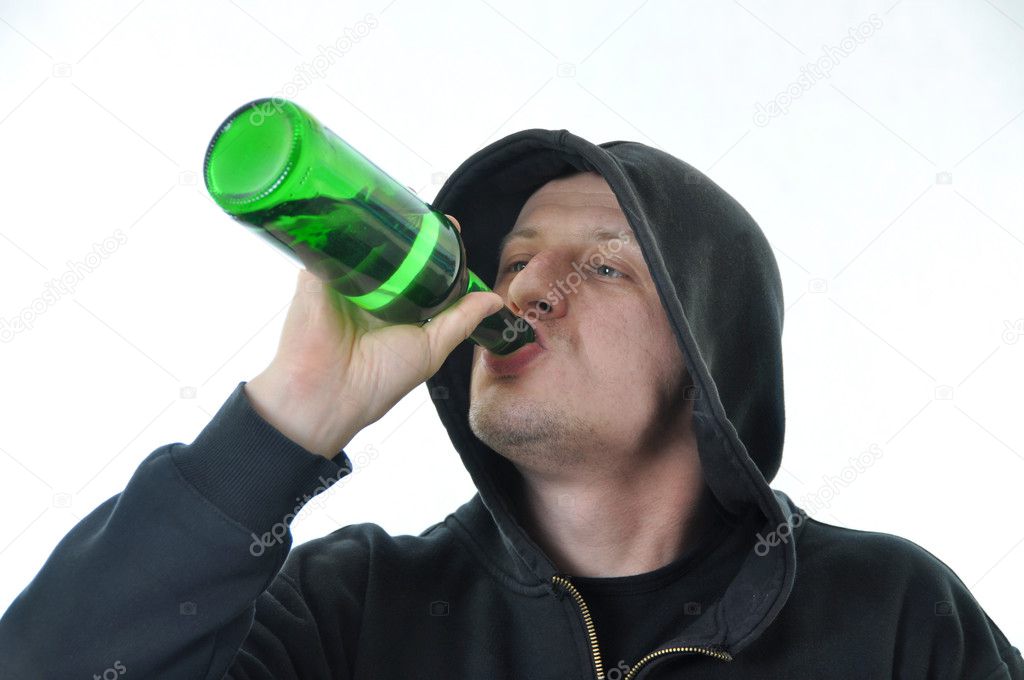 Young man drinking alcohol isolated