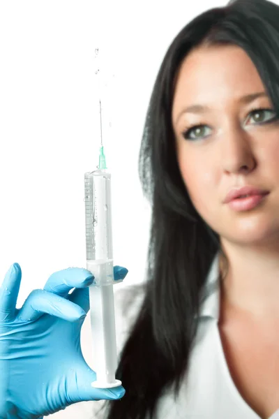 Young attractive nurse holding syringe isolated on white background — Stock Photo, Image