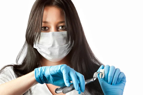 Dentista feminina em máscara segurando fórceps e dente isolado — Fotografia de Stock