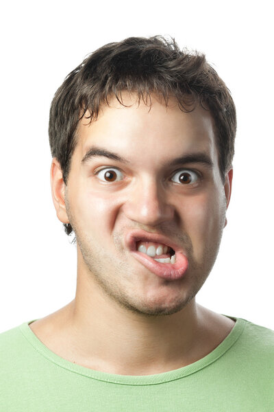 Portrait of young grimacing man isolated on white background