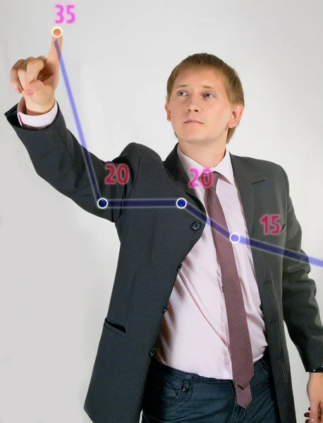 The young man in a suit shows the schedule — Stock Photo, Image