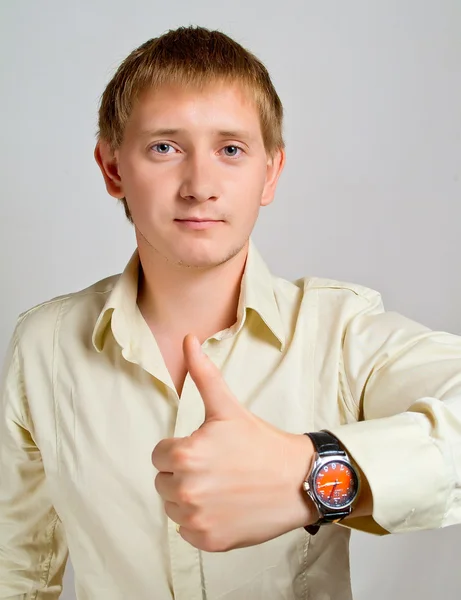 The young man has lifted the big finger on the left hand — Stock Photo, Image