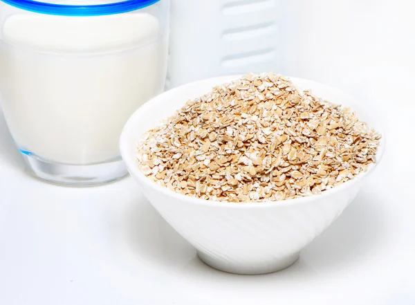 Porridge and milk on a white background — Stock Photo, Image